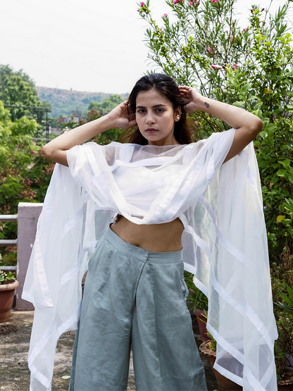 Statement Poncho Worn Over A Symmetric Silk Crop Top