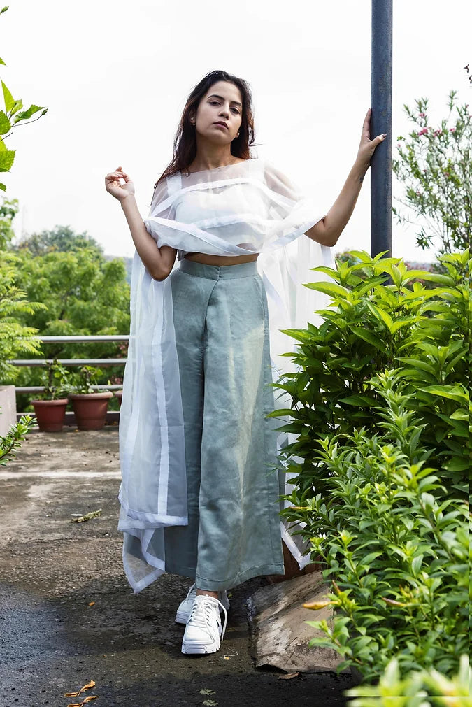 Statement Poncho Worn Over A Symmetric Silk Crop Top