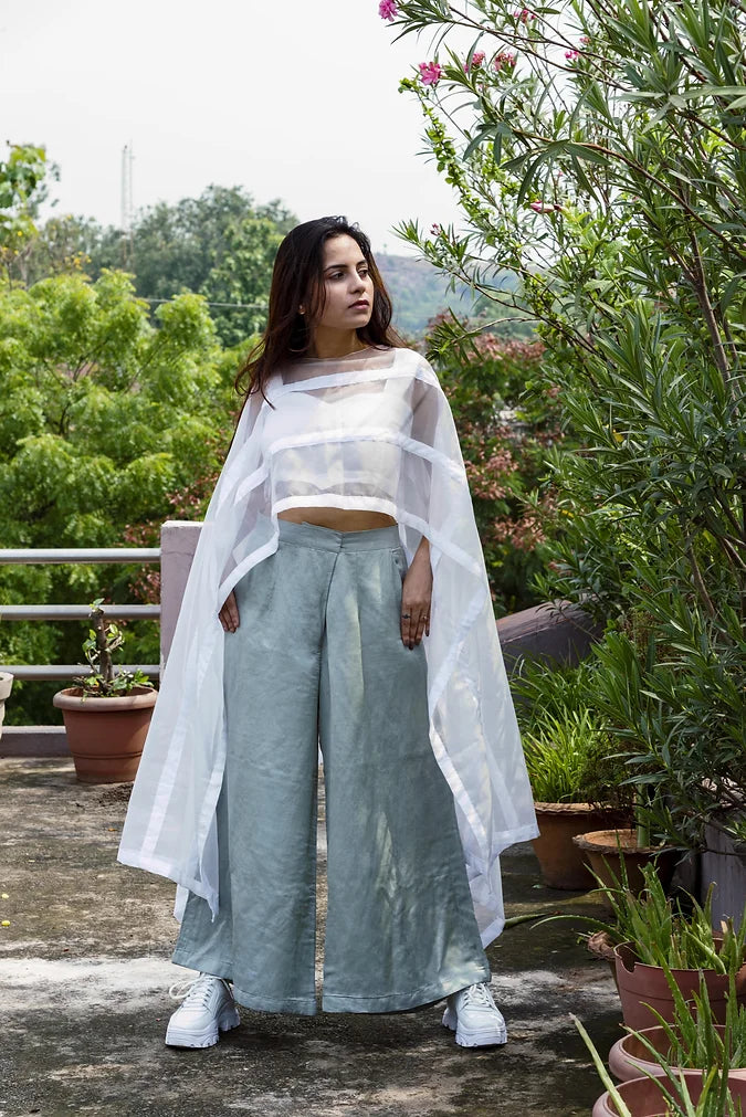 Statement Poncho Worn Over A Symmetric Silk Crop Top